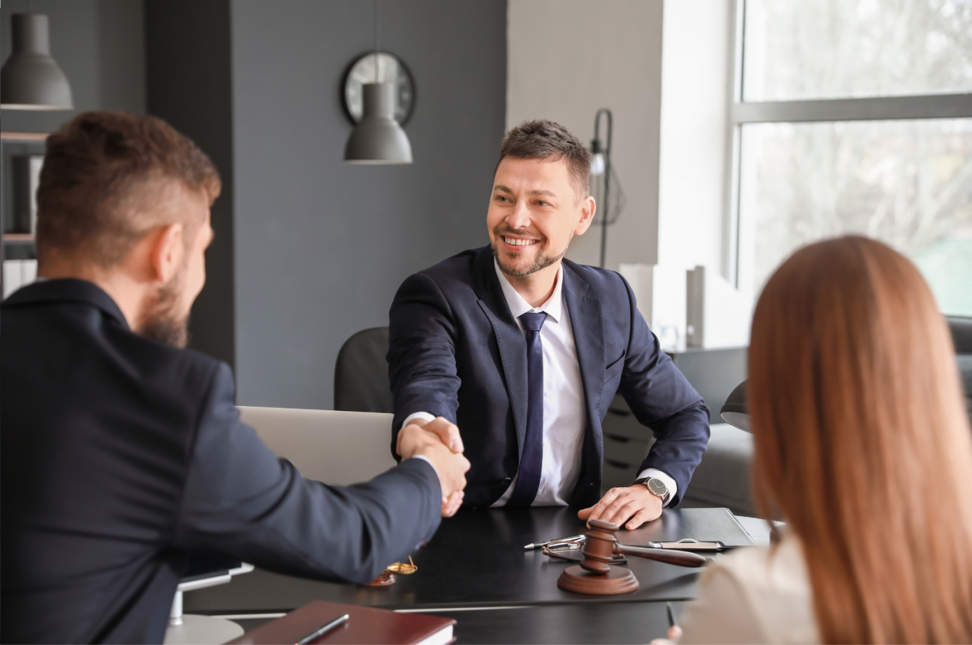 Lawyer in office shaking hands with client